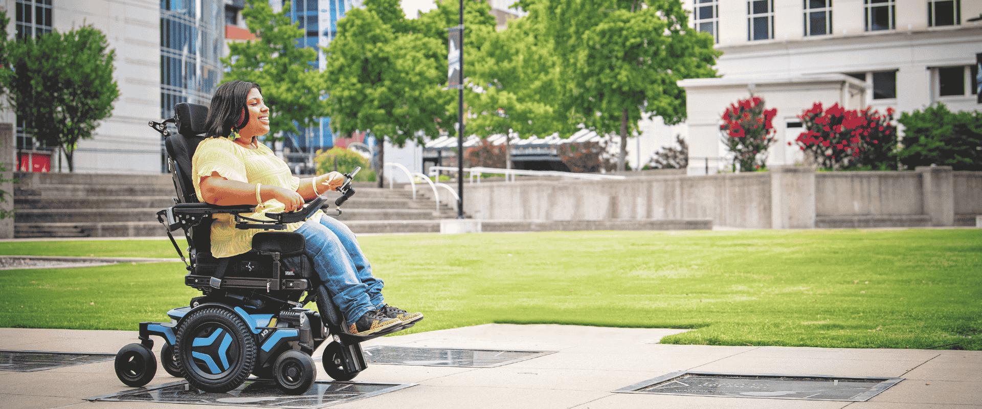 Woman in wheelchair smiling while other woman writing notes